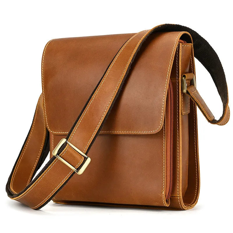 Men's brown leather shoulder bag with flip shoulder strap showing sewing line details and retro design