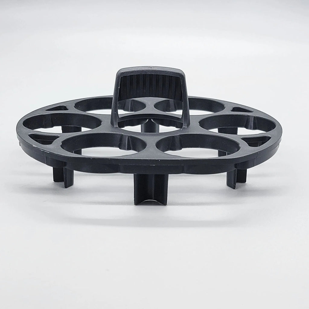 Black plastic egg holder cooking basket rack with retainer on a kitchen counter.