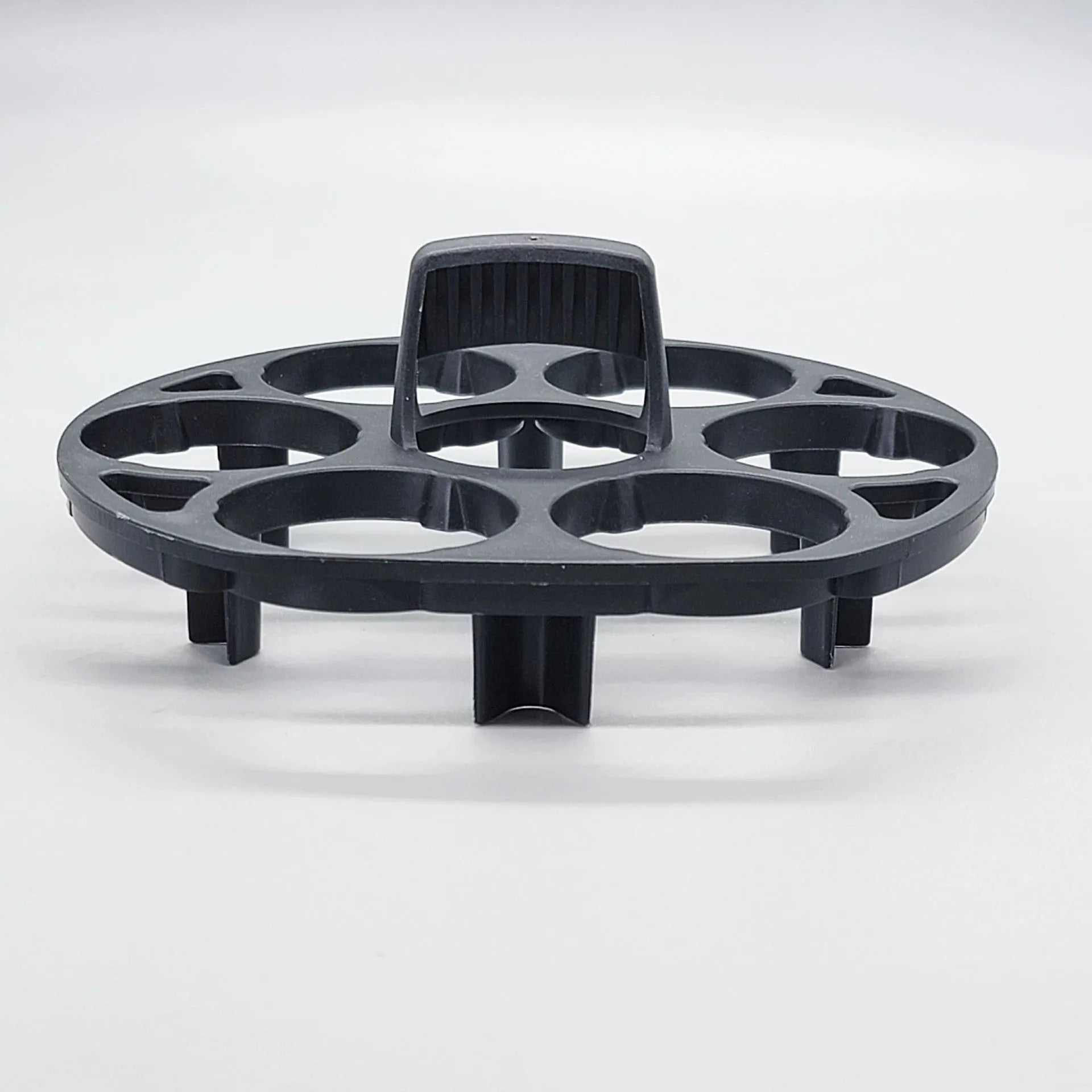 Black plastic egg holder cooking basket rack with retainer on a kitchen counter.