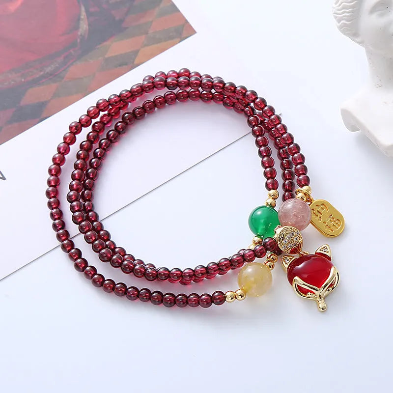Purplish red garnet crystal fox bracelet with adjustable rope fastening for women