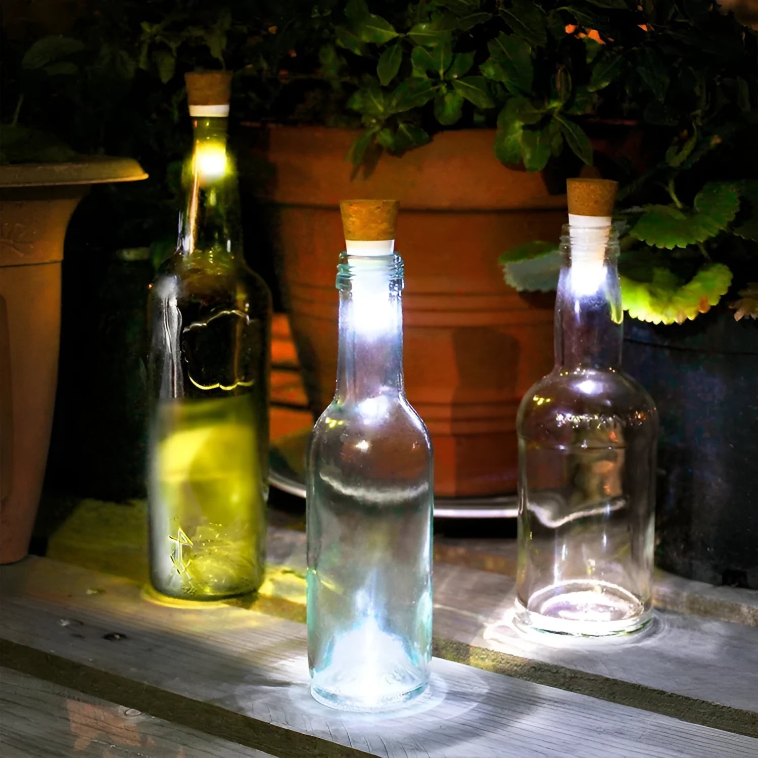 White plastic USB-rechargeable LED bottle cap cork light with micro-USB port, shown next to a whisky bottle.