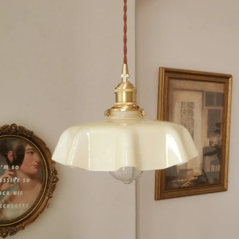 Medieval brass French chandelier light with glass shade, shown with adjustable cable.