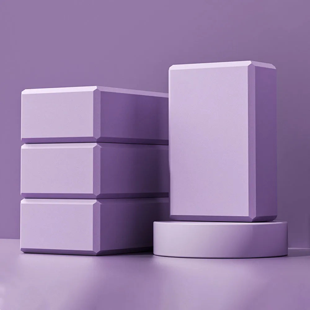 A solid-colour EVA foam yoga block with grip ridges, shown in blue, for yoga and fitness training.