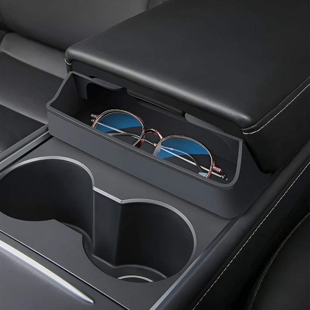 Black silicone glasses case installed inside a Tesla Model 3 or Y centre console armrest.