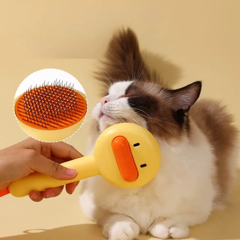 Small yellow duck-shaped pet grooming comb with open sections and needle bristles