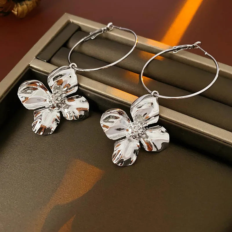 Gold and silver metal earrings with floral geometric design and electroplated finish
