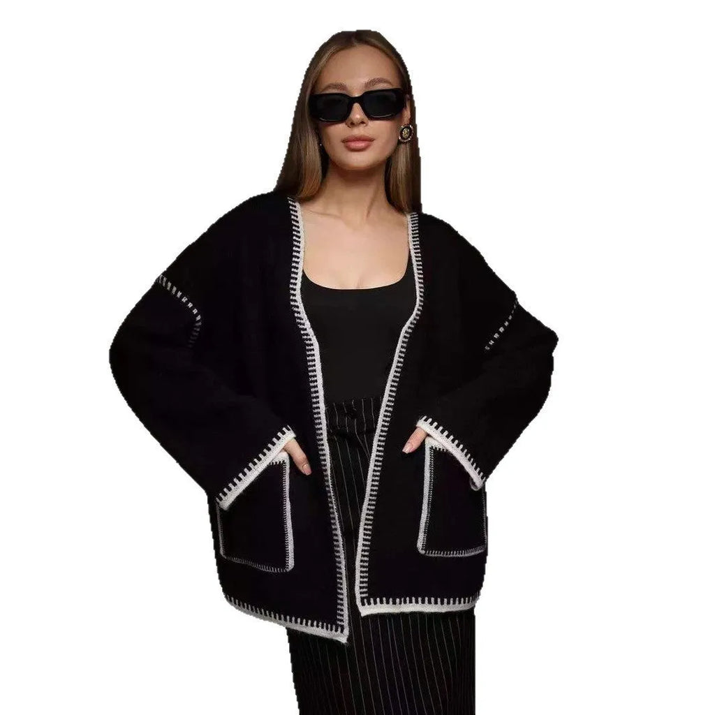 Loose black lace-up knitted cardigan on a hanger