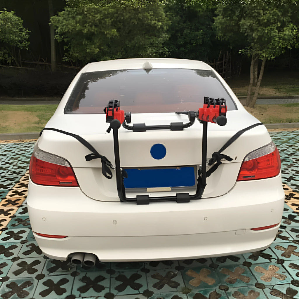 Black and red iron frame bike rack for car boot mounting, showing pull belt and tie rope fastenings.