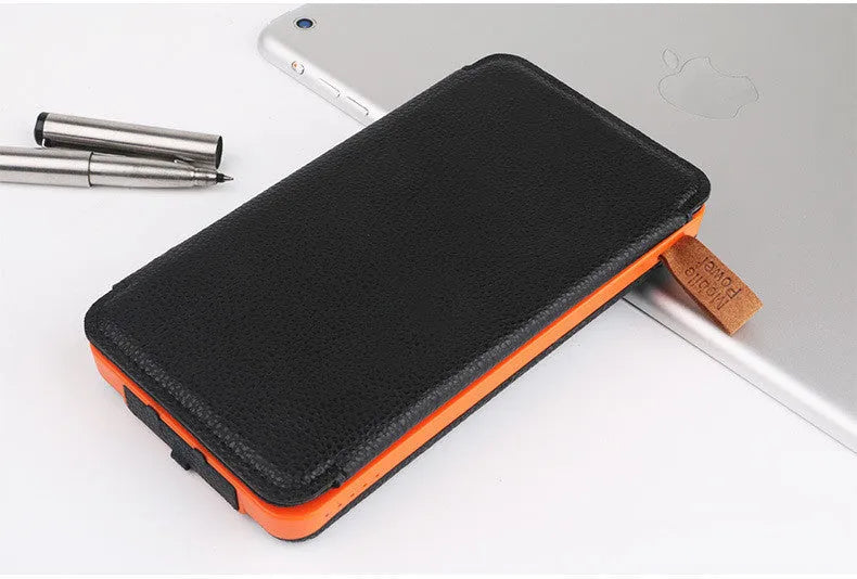 Black outdoor solar power bank with a leather finish, showing the solar panel and a single USB charging port.