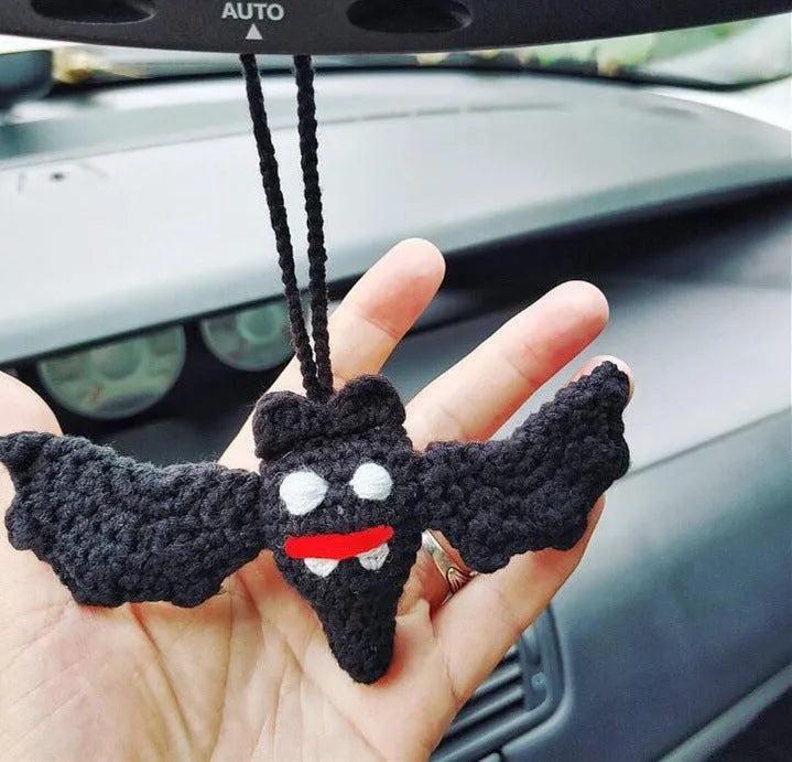Plush hand-woven car hanging ornament in a cartoon design, made from soft polyester fabric.