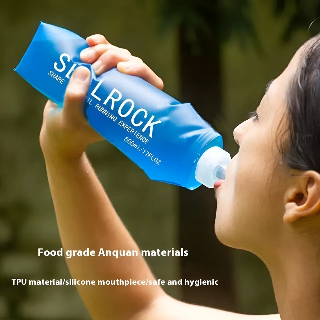 Close-up of a grey flexible plastic hydration straw with a textured grip and a blue silicone cap for mountain biking