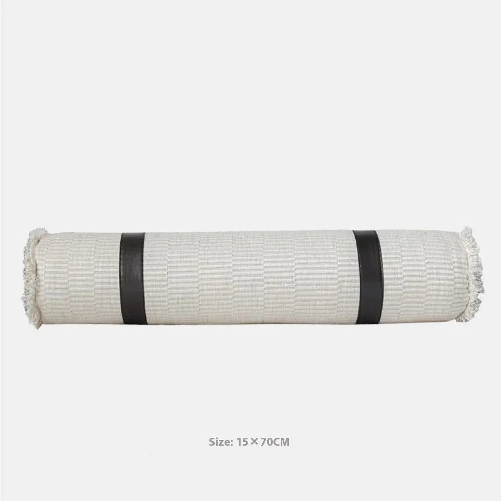 Modern minimalist grey and white plaid polyester bed runner with dark grey pillowcase and round leather pillow on bed