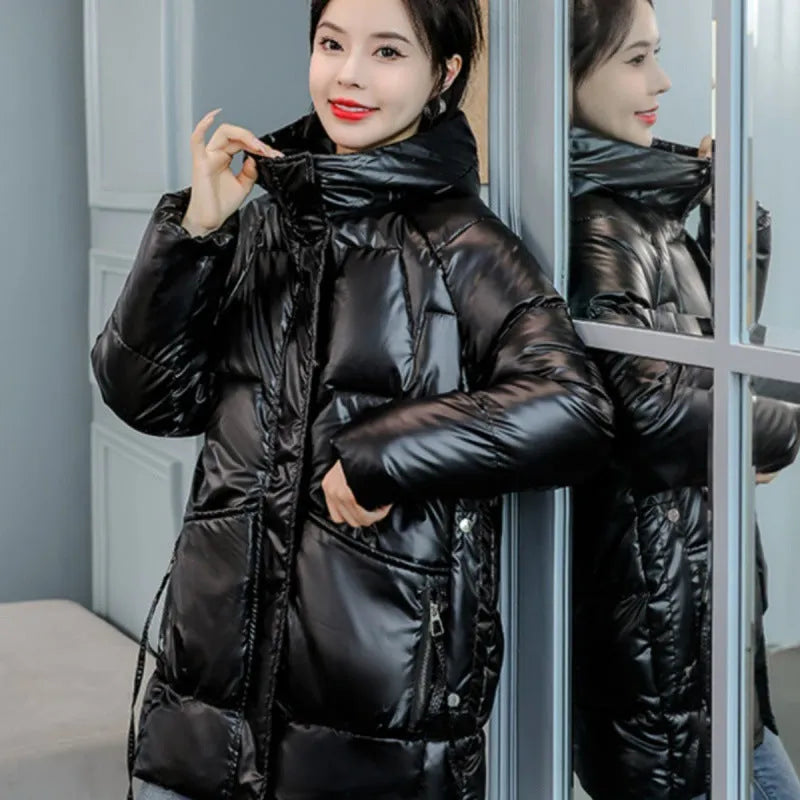 A woman wearing a green ultra-thin hooded winter jacket with long sleeves, showing the front design.