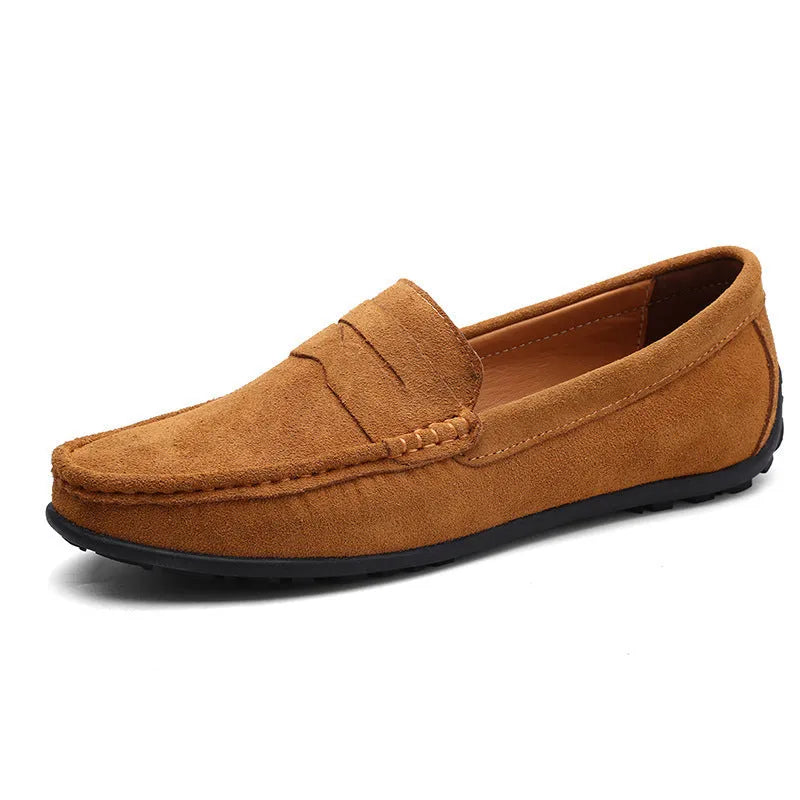 Men's suede leather Gommino loafers in black on a flat rubber sole, showing round toe and sewing line detail.