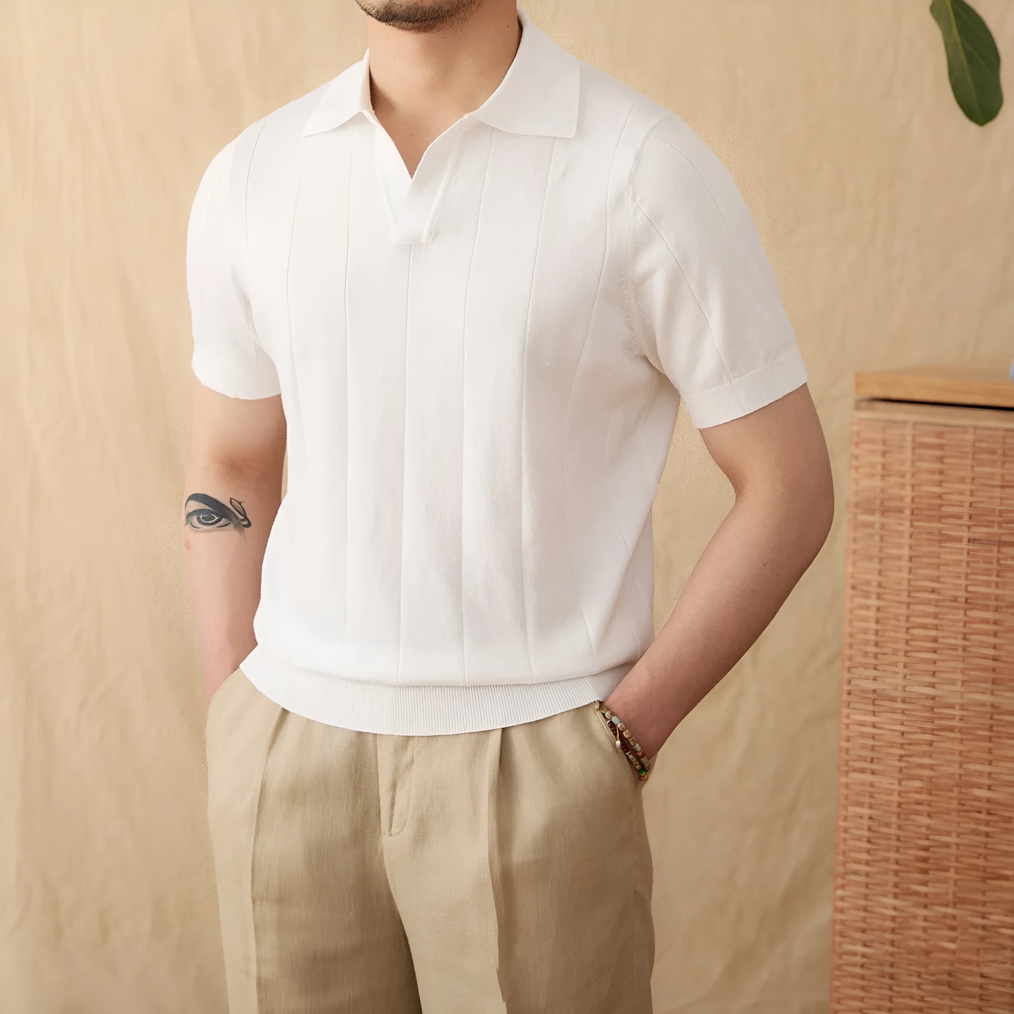 Men's purple short sleeve polo top with a knitted sunken stripe pattern and a classic collar.