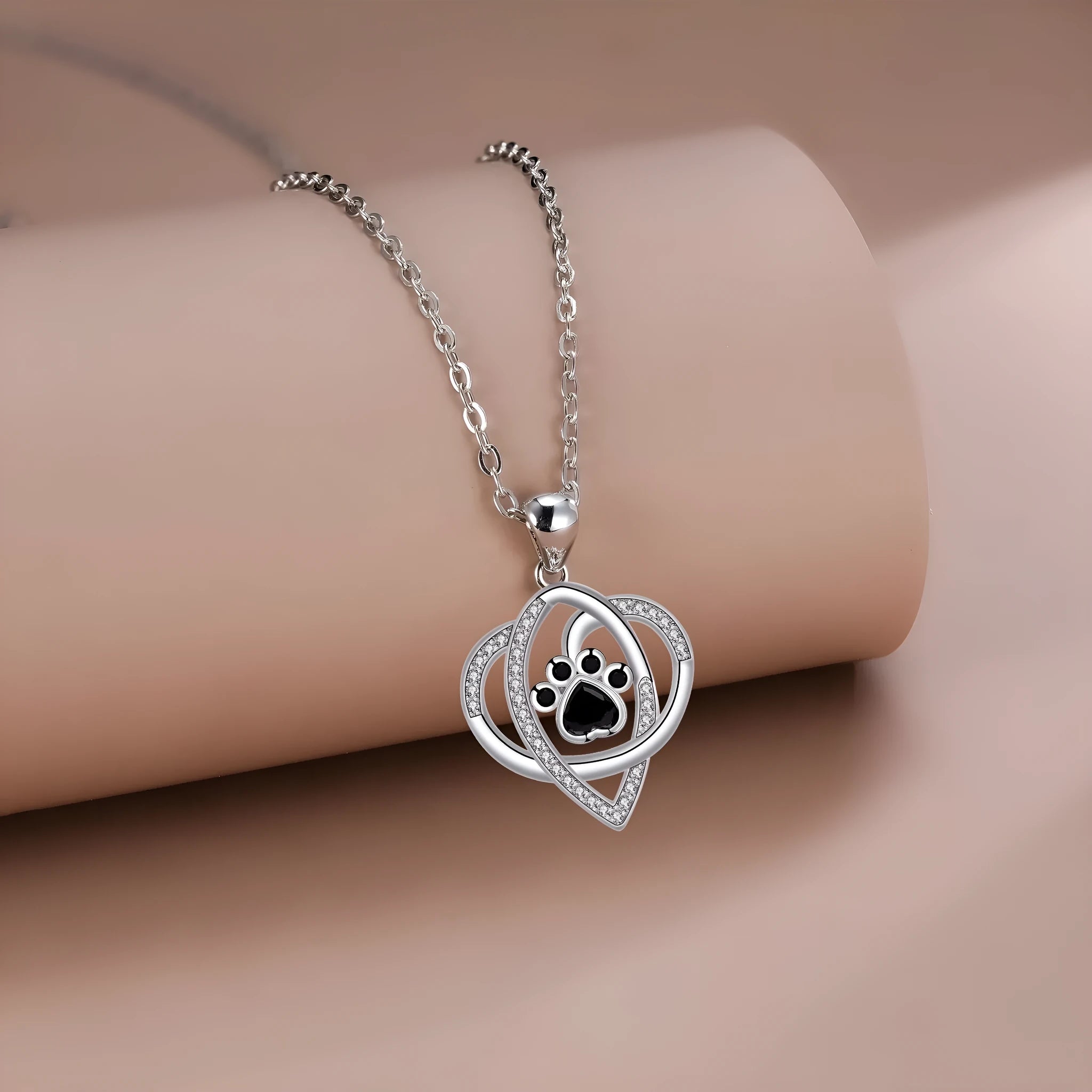Gold necklace with cat and dog paw prints pendant on cross chain