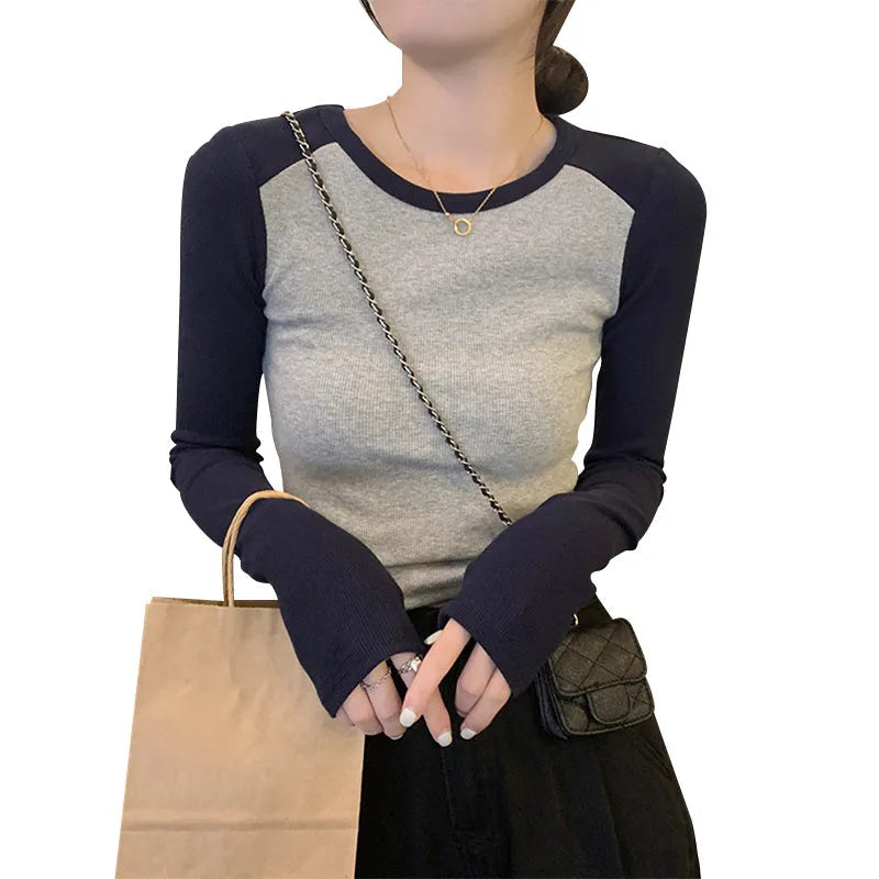 Women's oversized slim fit top with embroidery on the sleeves, shown in dark blue.