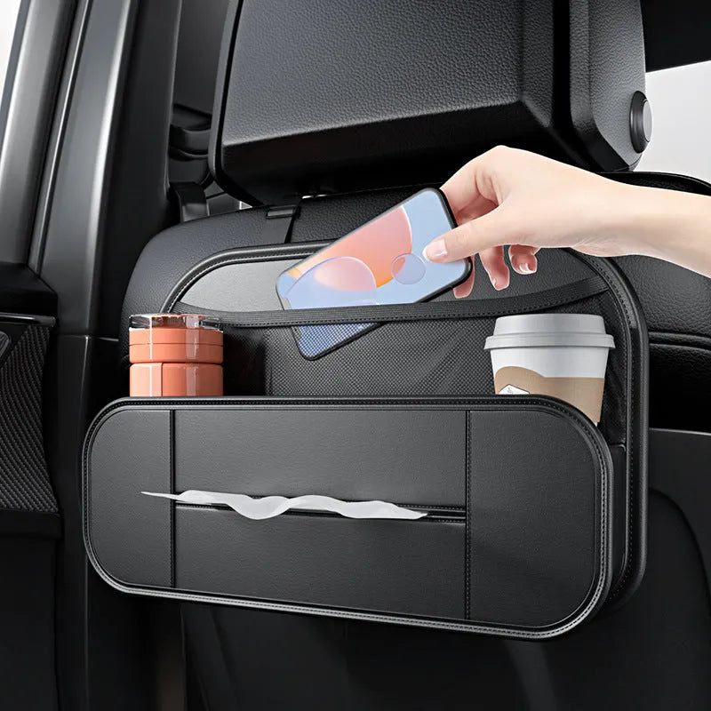 Black leather car seat rear storage bag with compartments, shown mounted on a car seat.