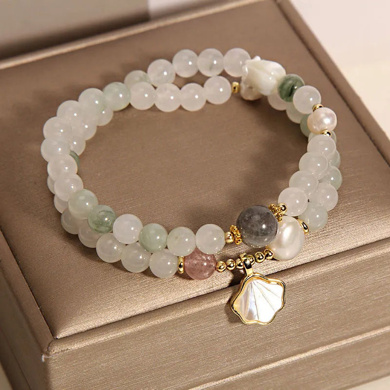 Women's crystal bracelet with a green Tianshan jade shell ginkgo leaf pendant, gold-plated accents, and rhinestones.