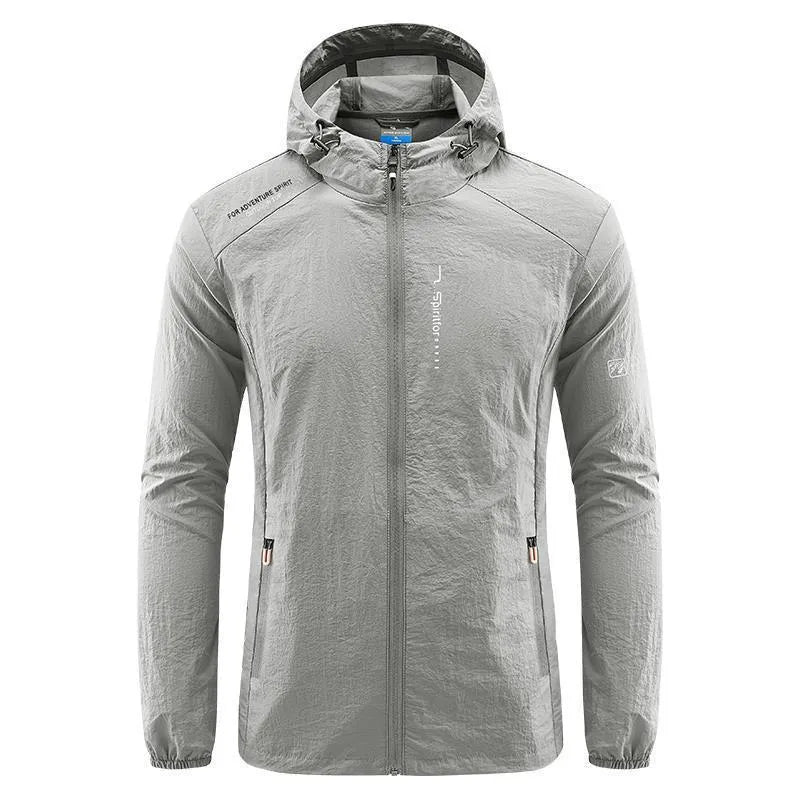 Man wearing a loose-fit light grey hooded nylon jacket for summer sun protection.