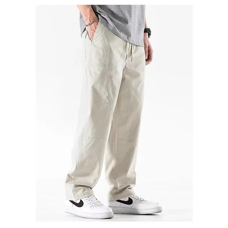 Casual wide-leg cotton trousers in milky white on a model, showing the relaxed fit and trousers-mouth silhouette.