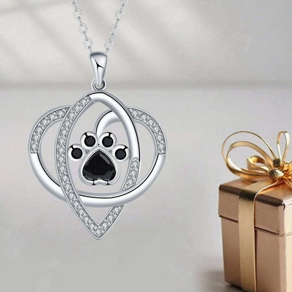 Gold necklace with cat and dog paw prints pendant on cross chain