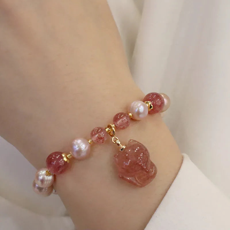 Women's light pink freshwater pearl bracelet with strawberry quartz beads and fox charm