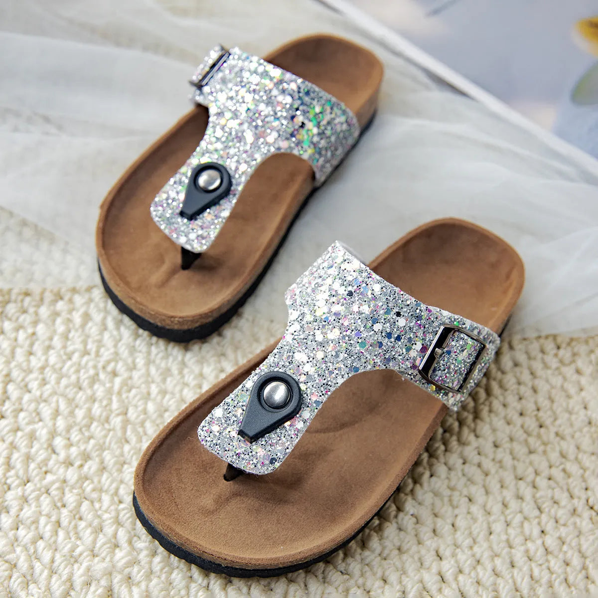 Gold frosted cork flip-flops with artificial leather upper and textured PVC sole.