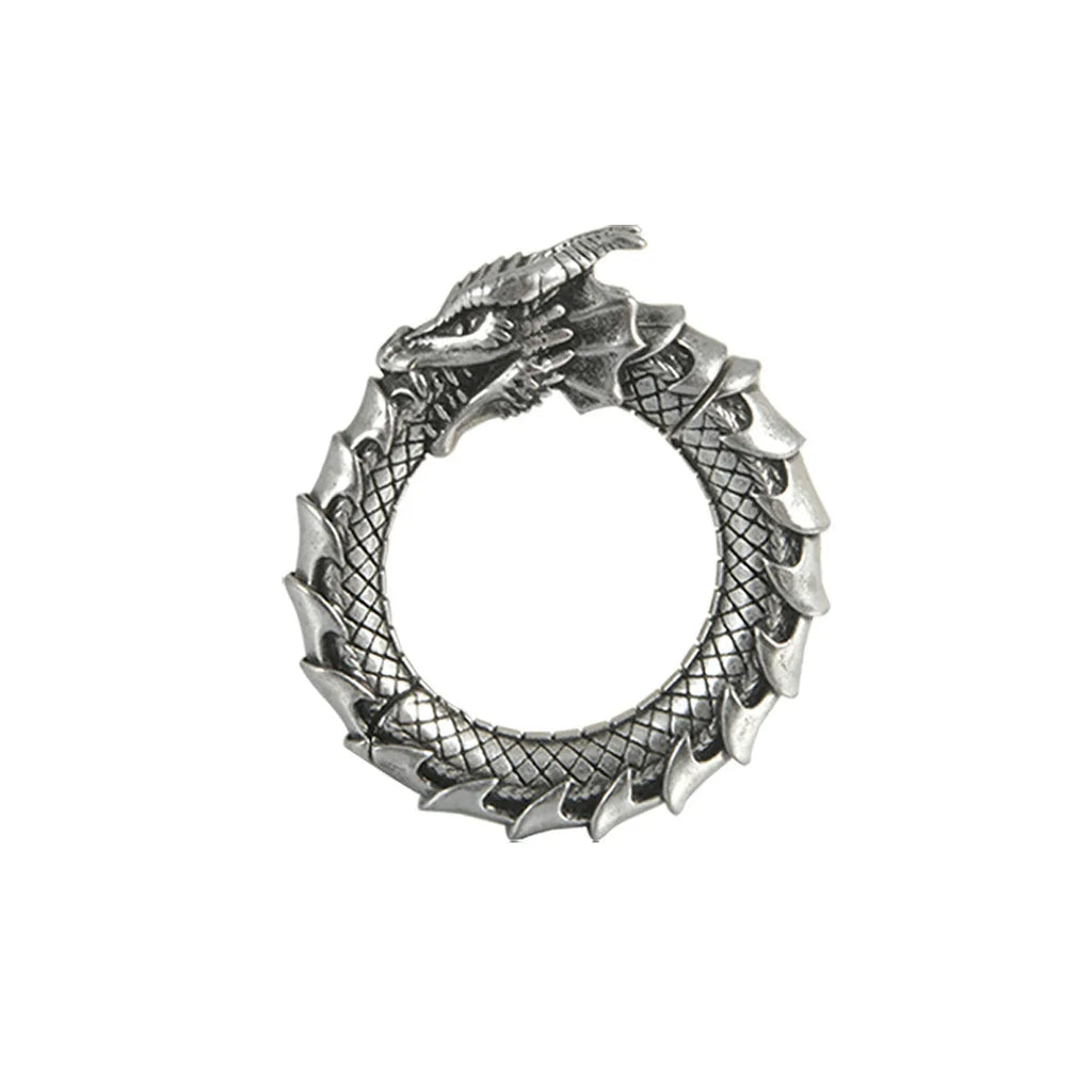 Pair of antique silver dragon-shaped geometric earrings with hollow-out design on a plain background.