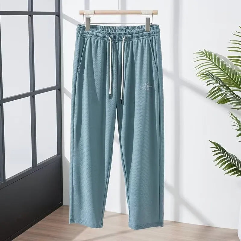 Men's thin grey ice silk casual trousers with a loose straight-leg fit and ankle-tied detail.