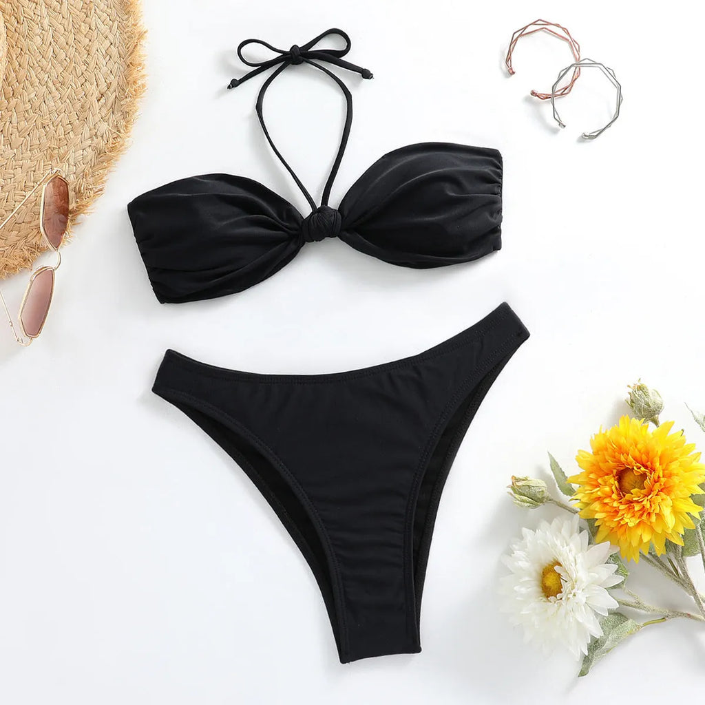Black women's bikini set with lace-up front tube top and matching briefs.