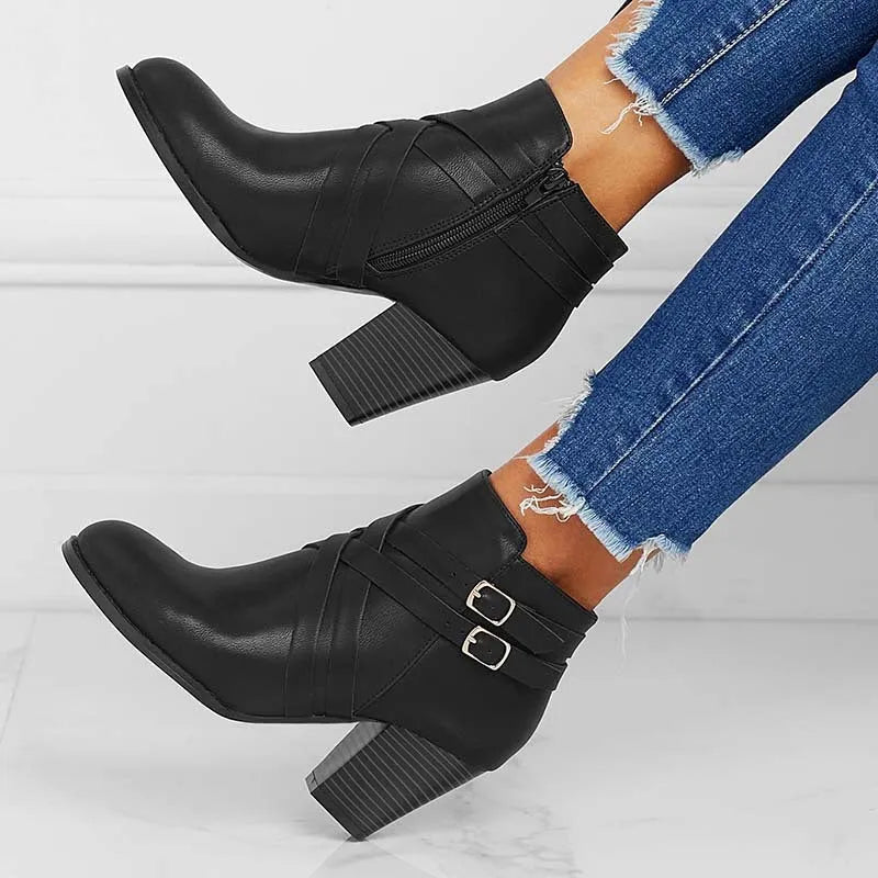 Plus size black short boot with side zipper, buckle, and a 7cm thick rubber heel.