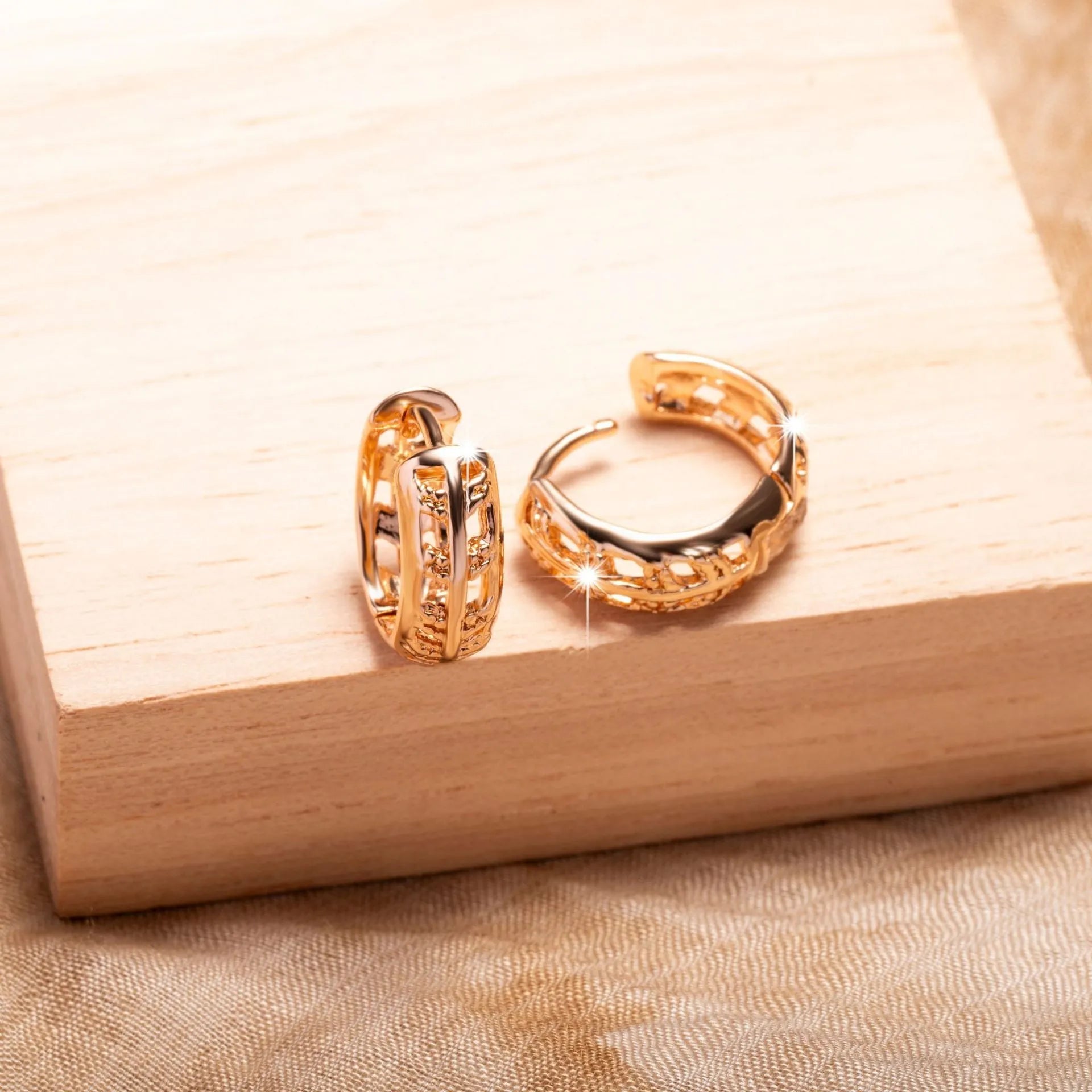 Rose gold plated copper earrings with hollow heart and leaf shapes, shown from front, approx 2.5cm tall.