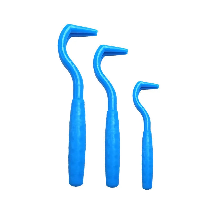 Pack of three coloured plastic tick removal hooks for dogs on a plain background.