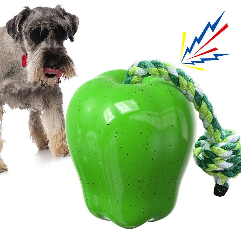 Green and red plastic dog molar toy with a food-dropping ball, shown in squeaky apple and outdoor travel designs.