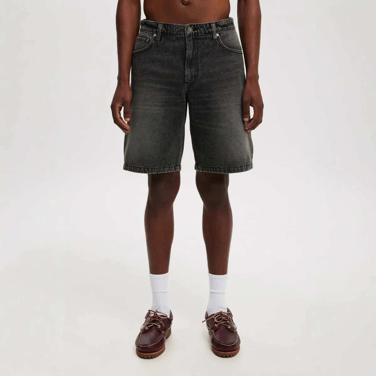 Men's loose fit light blue cotton denim straight leg trousers on a neutral background