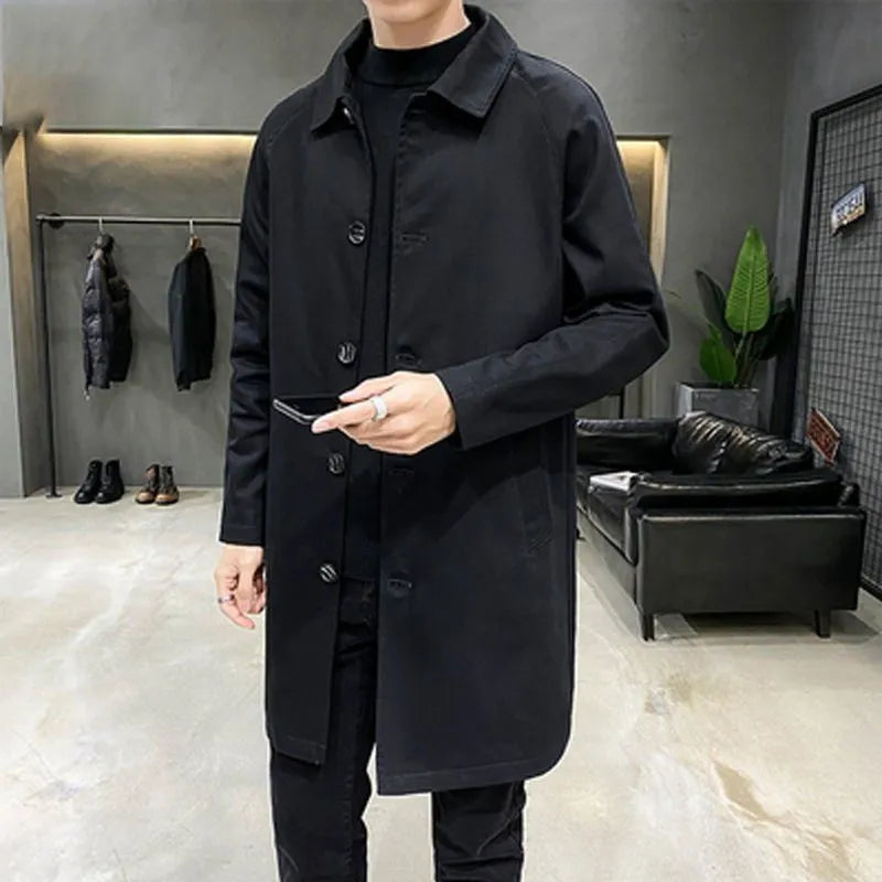 Man wearing a khaki-coloured, loose-fit mid-length trench coat made of rabbit fur.