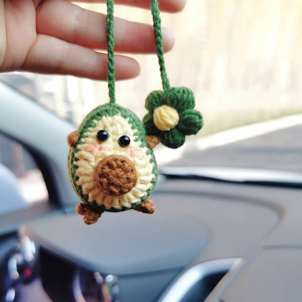 Handmade crocheted wool car pendant in avocado, pink rainbow, or red rainbow colour with cartoon flower design.