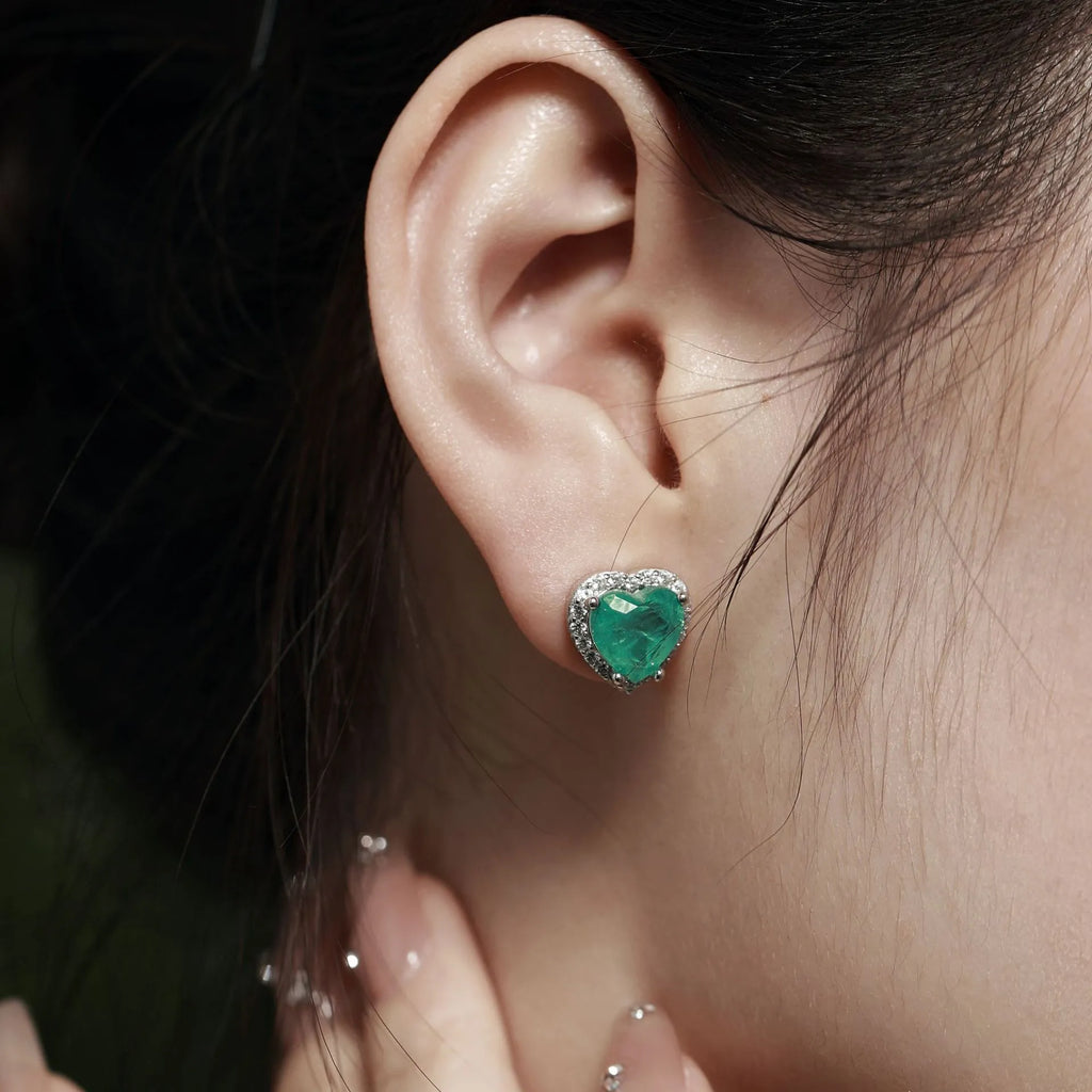 Green platinum 925 silver heart stud earrings on white background