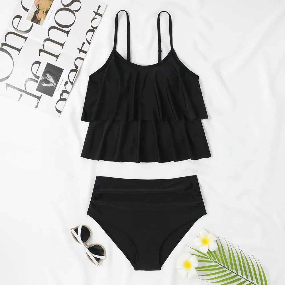 Black high-waist swimsuit briefs with a double-layer front and a matching sleeveless top on a mannequin.