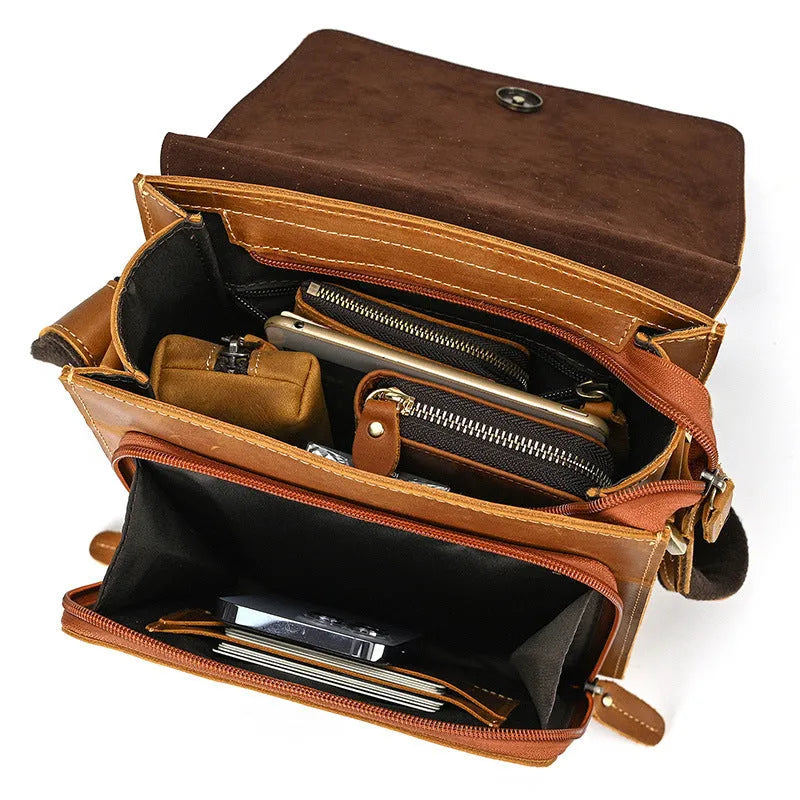 Men's brown leather shoulder bag with flip shoulder strap showing sewing line details and retro design