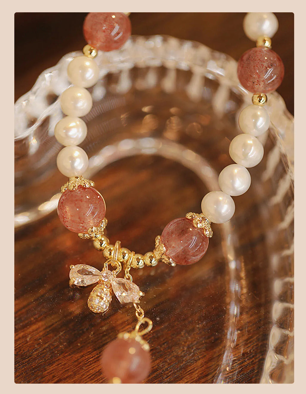 Handmade women's strawberry quartz crystal bracelet with a decorative bow clasp.