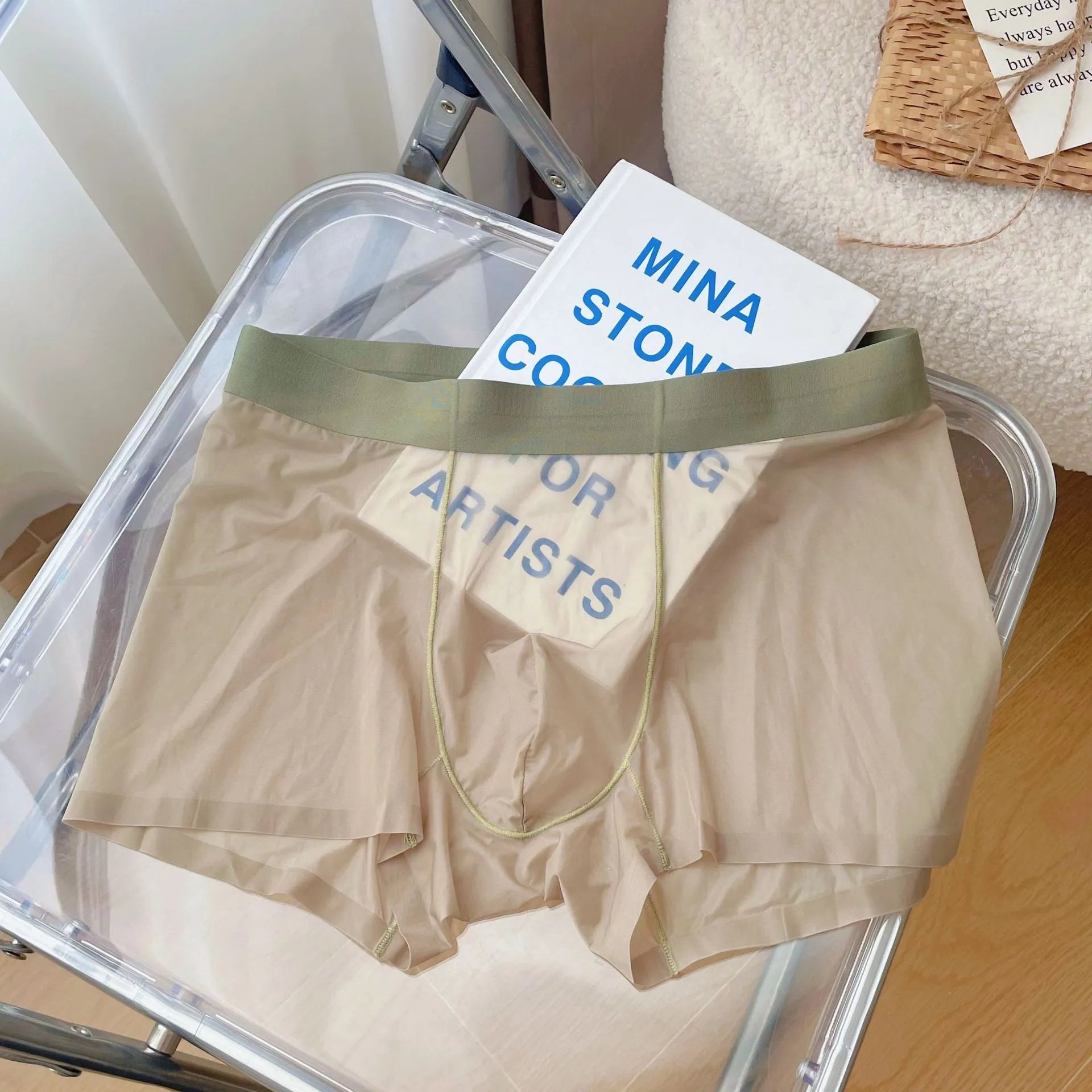 Men's seamless boxer shorts in a thin, knit fabric on a grey background.