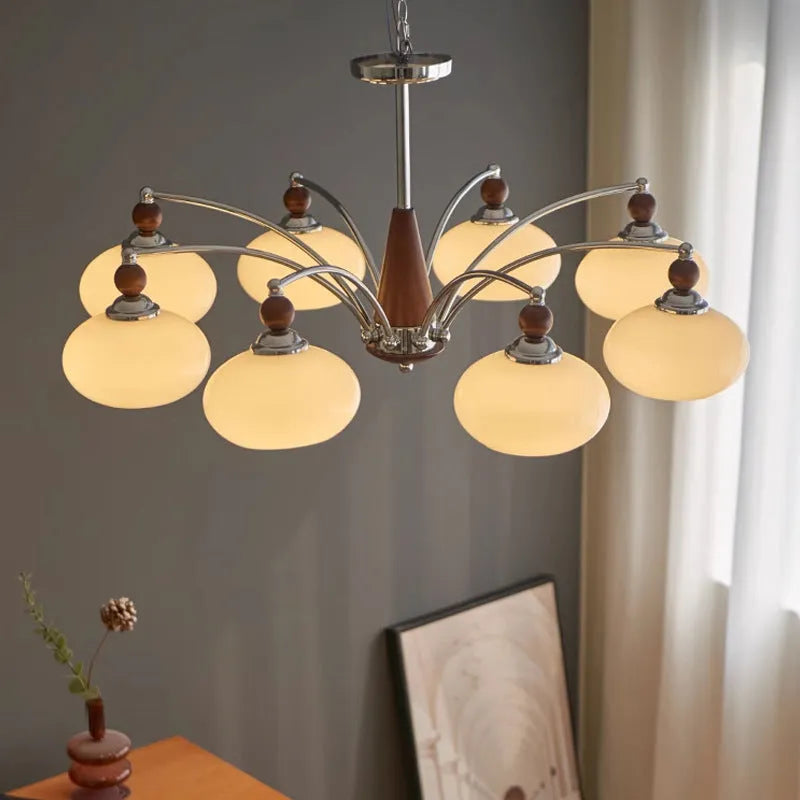 Persimmon glass chandelier with multiple chrome lampshades in a Middle Ancient style, hung from a ceiling.