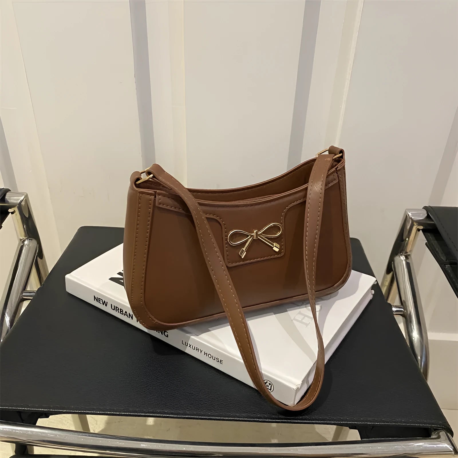 Western style PU leather shoulder bag in horizontal square shape with bow decoration, shown in rose pink colour.