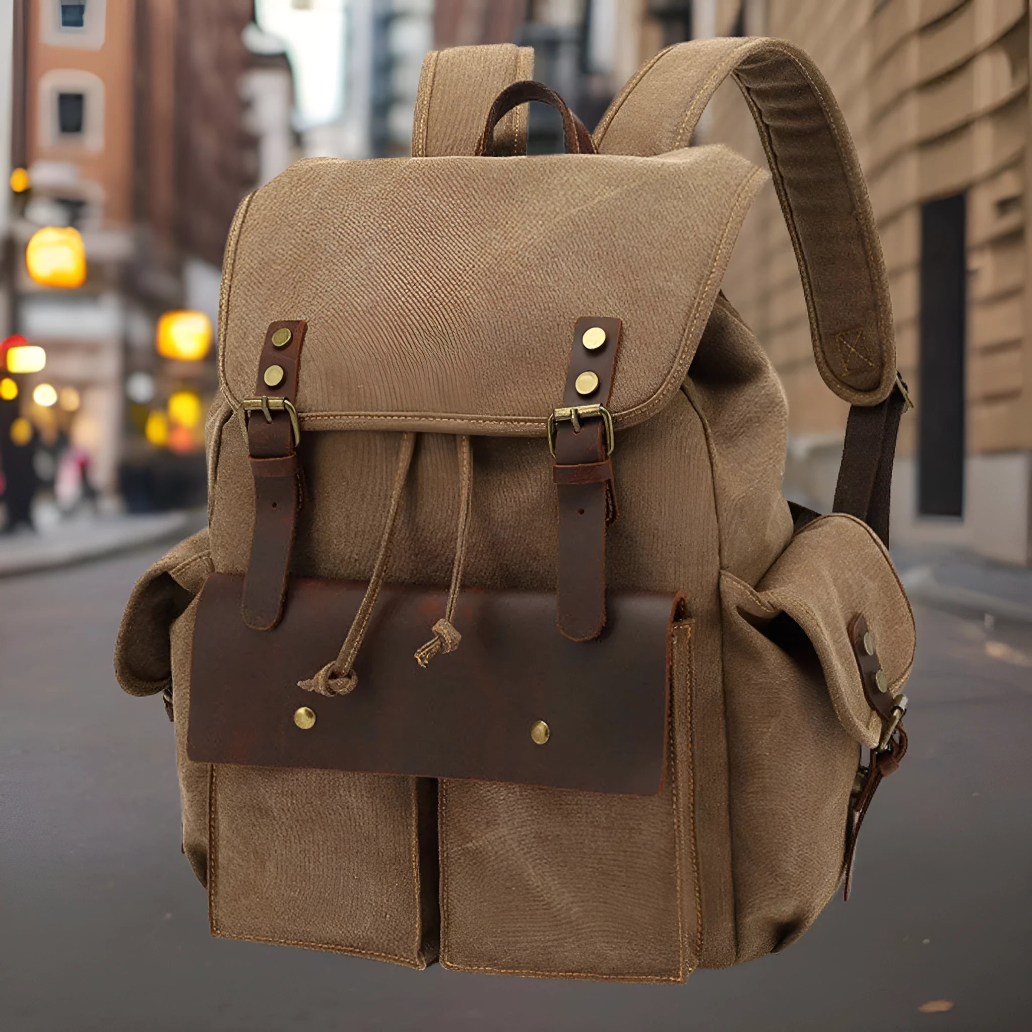 Retro canvas backpack in military green with antique bronze hardware showing front compartment organisation