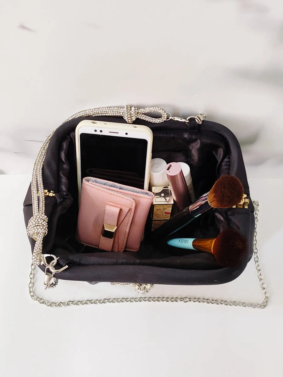 Women's diamond quilted crossbody messenger bag in soft polyester with chain detailing and document compartment