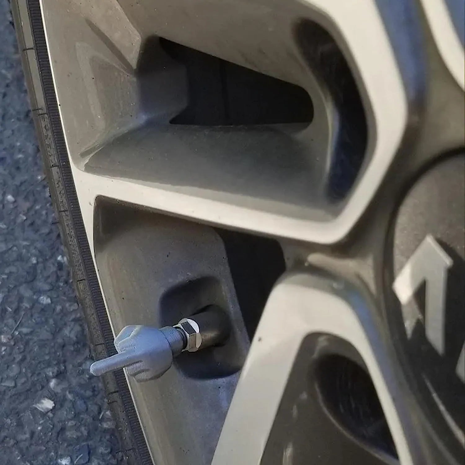 Four latex tyre valve caps - two black and two skin colour pieces for car, bike, and scooter valves
