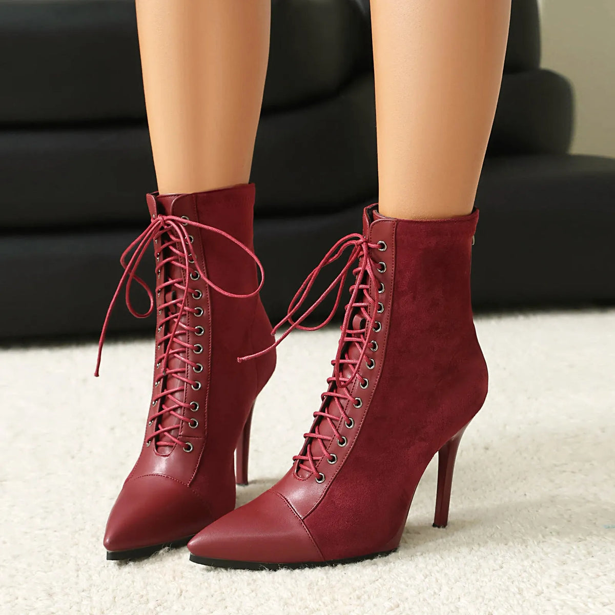 Women's suede pointed toe ankle boots with stiletto heel, back zip, and drawstring patchwork detail in black, brown, or wine red.