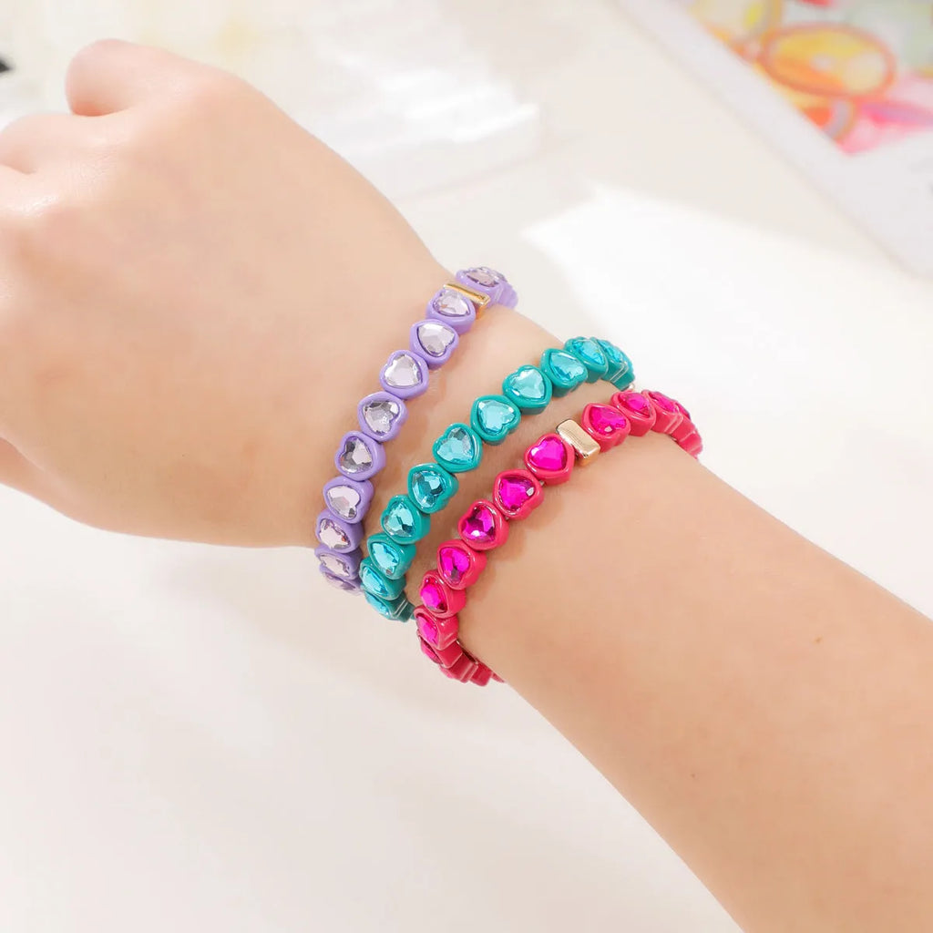 Rainbow enamel heart charm bracelet on alloy base with diamond treatment, stretch band, multicolour design.